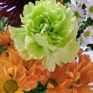 Colorful bouquet with green and orange flowers.