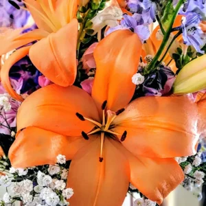 Orange lily with mixed floral bouquet.